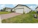 Beautiful home with a brick-paved driveway, two-car garage, and lush green lawn at 3069 Cassidy Ln, Haines City, FL 33844