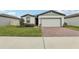Charming one-story home featuring a brick driveway, well-maintained lawn, and inviting curb appeal at 3069 Cassidy Ln, Haines City, FL 33844