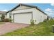 Well-kept home with a two-car garage, easy access to utilities and a well manicured lawn at 3069 Cassidy Ln, Haines City, FL 33844