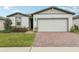Charming one-story home with a two-car garage, landscaped front yard, and a welcoming entrance at 3069 Cassidy Ln, Haines City, FL 33844