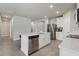 Bright kitchen featuring white cabinets, stainless steel appliances, a center island, and gray tile floors at 3069 Cassidy Ln, Haines City, FL 33844