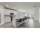 Open kitchen featuring white cabinets, stainless steel appliances, island with seating and view to the living room at 3069 Cassidy Ln, Haines City, FL 33844