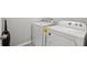 A well-lit laundry room featuring a white washing machine and dryer and light hardwood-style flooring at 3069 Cassidy Ln, Haines City, FL 33844