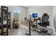 This bright home office has a gray tiled floor and a window with blinds at 3069 Cassidy Ln, Haines City, FL 33844