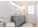 Contemporary bathroom with dual sinks, white marble tile, and bright lighting at 3111 Indian Trl, Eustis, FL 32726