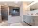 Bathroom with double sink vanity, skylight, and bathtub with shower combo offers a spa-like feel at 3111 Indian Trl, Eustis, FL 32726