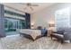 Bedroom features ceiling fan, soft rug, neutral tones, and glass door access to the outdoor area at 3111 Indian Trl, Eustis, FL 32726