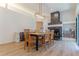 Dining room with modern light fixture and fireplace with firewood storage and white marble detail at 3111 Indian Trl, Eustis, FL 32726