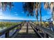 Picturesque dock with Spanish moss, a serene view of the water, and lush vegetation at 3111 Indian Trl, Eustis, FL 32726