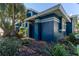 Side view of blue home with lush landscaping at 3111 Indian Trl, Eustis, FL 32726