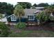 Charming home featuring lush landscaping, mature palms, and a freshly painted exterior at 3111 Indian Trl, Eustis, FL 32726