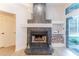 Living room fireplace with tiled facade, mantle, and wood storage is perfect for relaxing at 3111 Indian Trl, Eustis, FL 32726