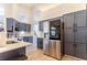Modern kitchen with stainless steel appliances, gray cabinets, and bright lighting at 3111 Indian Trl, Eustis, FL 32726