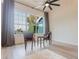 Cozy sitting area with plush rug, accent table, and large windows providing ample natural light at 3111 Indian Trl, Eustis, FL 32726