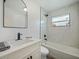 Updated bathroom featuring white marble-style tile surround, shower-tub combination and black fixtures at 3117 Shady Pine Ave, Winter Park, FL 32792