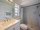 Bathroom showcasing a vanity, framed mirror and shower with gray tile surround at 3117 Shady Pine Ave, Winter Park, FL 32792