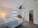 Cozy bedroom with a ceiling fan and a view of the backyard through the window at 3117 Shady Pine Ave, Winter Park, FL 32792