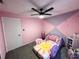 Pink bedroom featuring playful decor, ceiling fan and a carpet at 3117 Shady Pine Ave, Winter Park, FL 32792