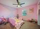 Pink bedroom featuring playful decor, ceiling fan and a carpet at 3117 Shady Pine Ave, Winter Park, FL 32792