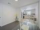 Dining area with table and view into the updated kitchen with white cabinetry and stainless appliances at 3117 Shady Pine Ave, Winter Park, FL 32792