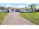 This home has a brick driveway, an attached garage, and a well manicured lawn with room to play at 3117 Shady Pine Ave, Winter Park, FL 32792