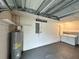 A spacious garage featuring a water heater, electrical panel, and washer and dryer hookups at 3117 Shady Pine Ave, Winter Park, FL 32792