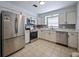 Modern kitchen featuring stainless steel appliances, white cabinets, and granite countertops at 3117 Shady Pine Ave, Winter Park, FL 32792