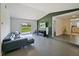 Open-concept living room with sliding glass doors to the backyard, and view to the kitchen and dining room at 3117 Shady Pine Ave, Winter Park, FL 32792