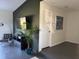 Cozy living room with a modern entertainment center, plant and dark flooring at 3117 Shady Pine Ave, Winter Park, FL 32792