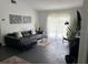 Open-concept living room with a comfortable couch, natural light, and modern decor at 3117 Shady Pine Ave, Winter Park, FL 32792