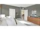 Bright bedroom with a view into the living room with wood dresser and neutral decor at 3456 Costello Cir, Winter Haven, FL 33884