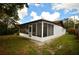 Angle view of the screened-in patio and surrounding green yard at 380 Banyan Dr, Maitland, FL 32751