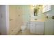 Well-lit bathroom with tiled shower, toilet, and vanity with storage at 380 Banyan Dr, Maitland, FL 32751