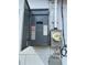 Close-up of a grey electrical panel with an open door on a textured white wall at 380 Banyan Dr, Maitland, FL 32751