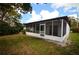 Back exterior view of screened porch leading to lush backyard at 380 Banyan Dr, Maitland, FL 32751