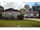 Inviting single-story house featuring stone accents, a lush green lawn, and a paved driveway at 380 Banyan Dr, Maitland, FL 32751
