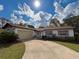 Charming single-story home featuring a well-maintained lawn, inviting driveway, and attached garage at 380 Banyan Dr, Maitland, FL 32751
