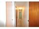 Bright hallway with neutral carpet and a lighted ceiling, connecting various rooms at 380 Banyan Dr, Maitland, FL 32751