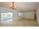 Open living room with access to a screened porch, neutral carpet, and lots of light at 380 Banyan Dr, Maitland, FL 32751