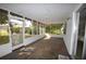 Enclosed porch area with stone flooring and screens offering views of the outdoor landscape at 380 Banyan Dr, Maitland, FL 32751