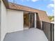 A balcony featuring a gray concrete floor and dark metal railing, with a sliding glass door leading inside at 4036 Shannon Brown Dr, Orlando, FL 32808