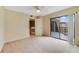 Bedroom featuring balcony access, neutral carpeting, and ample natural light at 4036 Shannon Brown Dr, Orlando, FL 32808