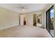 Bright bedroom with neutral carpet, ceiling fan, and sliding glass doors to balcony at 4036 Shannon Brown Dr, Orlando, FL 32808