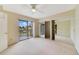 Bright bedroom with neutral carpet, ceiling fan, and sliding glass doors to balcony at 4036 Shannon Brown Dr, Orlando, FL 32808