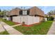 Charming townhouse featuring a white fence, well-manicured lawn, and a second-story balcony at 4036 Shannon Brown Dr, Orlando, FL 32808