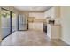 Bright kitchen features tile floors, stainless steel refrigerator, and white cabinets at 4036 Shannon Brown Dr, Orlando, FL 32808