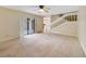 Spacious living room with plush carpeting, fan, and sliding door access to patio at 4036 Shannon Brown Dr, Orlando, FL 32808