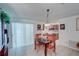 Cozy dining area with tile flooring, dining table, and a view into the kitchen and sliding glass doors at 4155 Westgate Rd, Orlando, FL 32808