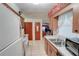Functional kitchen with white appliances, laminate countertops, and wood cabinets at 4155 Westgate Rd, Orlando, FL 32808