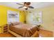 A sunny bedroom featuring a large bed, hardwood floors, and dual windows at 4227 Spring Ln, Lakeland, FL 33811